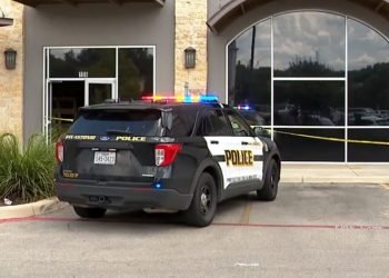 Man in critical condition after getting shot while laying carpet inside business