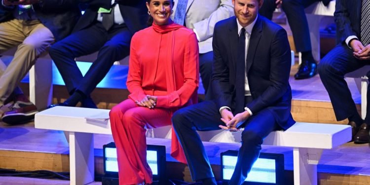 Meghan Markle Returns to the U.K. in Her Business as Usual Uniform – WWD